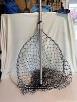 Full view of fish landing net showing frame, handle and net
