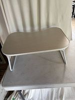 Top view of folding TV table on another table