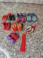 Group shot of all miniature shoes and tassel ornament