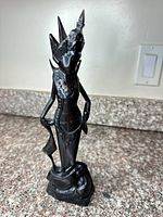 Full view of carved wooden statue on countertop