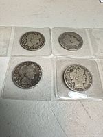 Group of four Barber Half Dollars in plastic flips