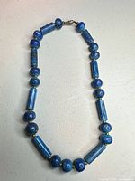 Full view of necklace showing bead shapes, color, and clasp