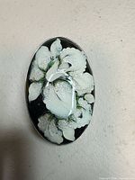 Front view showing enamel floral design