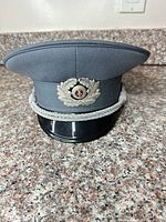 Front view showing insignia, chin cord, visor