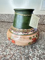 Front view of Bucana ceramic vase showing painted folk pattern and twine accent