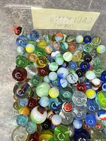 top view of assorted multicolor glass marbles in bin
