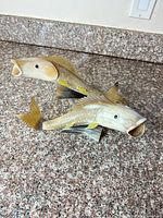 Both resin fish sculptures side by side on countertop