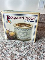 Front of original Rival Potpourri Crock box showing product image and branding
