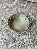 Top view showing interior surface, filigree sides and both handles