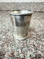 Side view of stacked silver-plated cup showing exterior condition