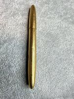 Full view of closed gold-tone pen