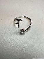 Front view showing solitaire cubic zirconia and pavé bar