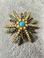 Front view of brooch showing stone and bead arrangement