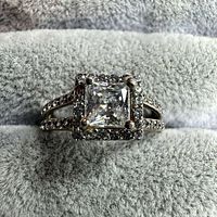 Front view showing princess-cut center CZ with halo