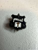 Front view of shield-shaped Lutheran enamel pin