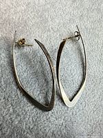 Both earrings front view on grey surface