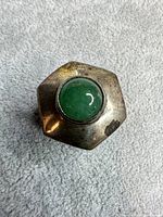 Top view showing hexagonal silver box with green jade cabochon inset