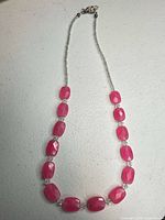 Full view of beaded necklace laid out showing length and bead arrangement