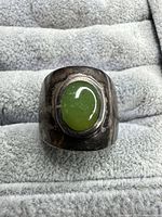 Front view of ring showing jade cabochon and tarnished silver band