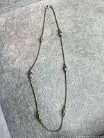 Full view of sterling station necklace showing overall length and bead placement
