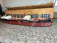 Port side view of model tanker ship with box behind