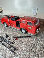 Full view of Texaco fire truck with accessories laid out