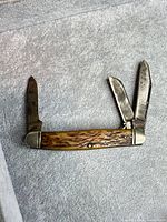 Knife fully open showing all three blades and handle