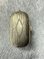 top view of ornate silver-tone vinaigrette box