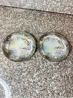 Both porcelain plates side by side showing full design and condition