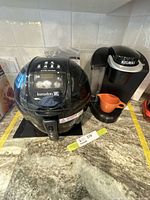 Kuradom air fryer beside Keurig brewer on countertop