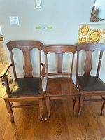 Front view of all three oak chairs showing styles and seats