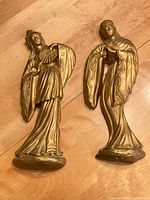 Front view of two gold-tone Marwal chalkware wall figures