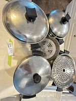 Stacked stainless pots, lids, and inserts