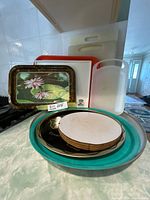 Assortment showing trays stacked on countertop, cutting boards behind