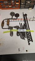 overall view of two brace drills, cluster of auger bits, long auger bits, and Irwin rack