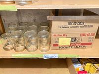 Shelf with grouped Kerr pint jars and box holding misc jars