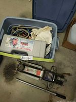 Blue tote with traction cable case, ropes, rags, jack partially visible
