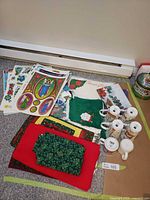 Group shot of mugs, linens, window clings and tins on floor