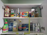 Overall view of two cabinet shelves filled with assorted cleaning products