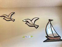 Overall view of three wall mirrors (sailboat, two seagulls) mounted on wall