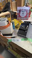 Group view showing drill bit sharpener, boxed grinding rest, driver bit case and other items