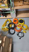 Group shot of all eight cords and reels on floor