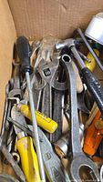Box containing wrenches, screwdrivers, hammer, files and other tools