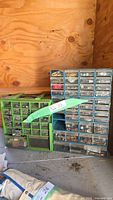 Both plastic drawer cabinets filled with hardware