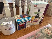 Three boxed/appliance items on floor: Donvier canister, Soehnle scale box, Yonanas box