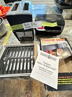 Overall lot showing toaster, panini press, cast iron pan and box