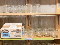 Shelves with multiple pint jars, half-pint jars, and original Kerr 12-pint box