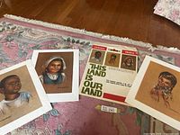 Three portrait prints and envelope displayed on rug
