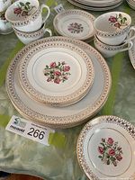 Stacked dinner and side plates, teacups and saucers showing Rosewood pattern