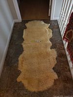 Full view of sheepskin rug on floor showing overall size and shape